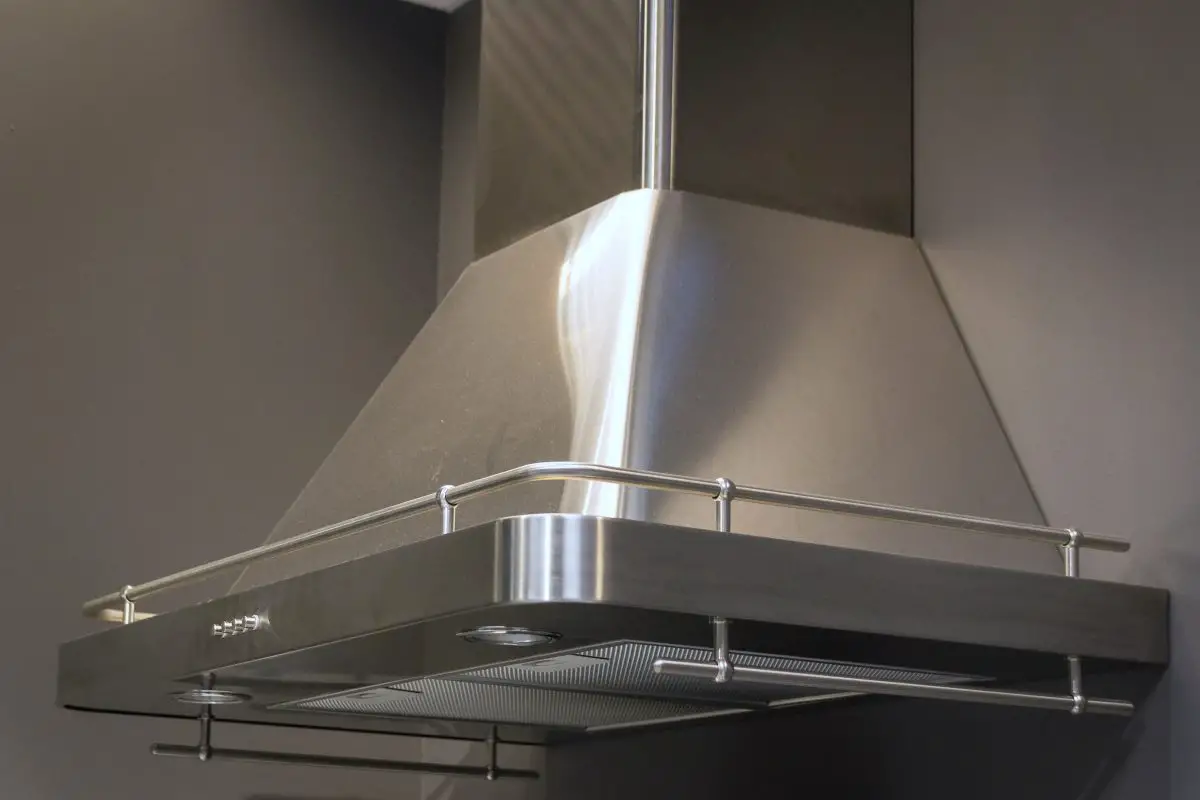 Image of a stainless steel wall mount range hood. Source: adobe stock