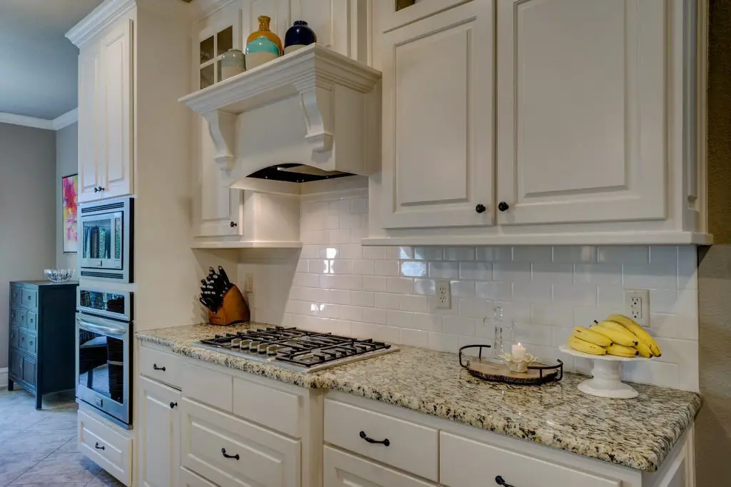 Image of a granite counter top and a range hood. Source: pixabay
