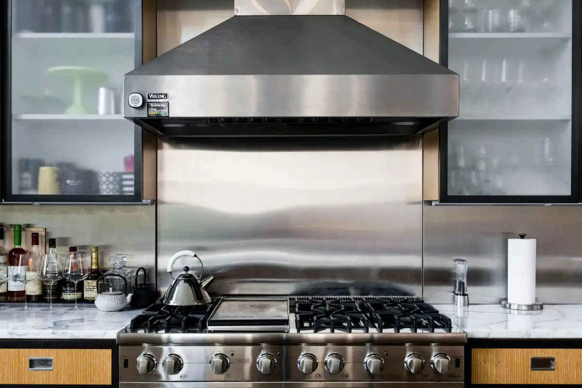 Image of a house with stainless steel range and range hood. Source: unsplash