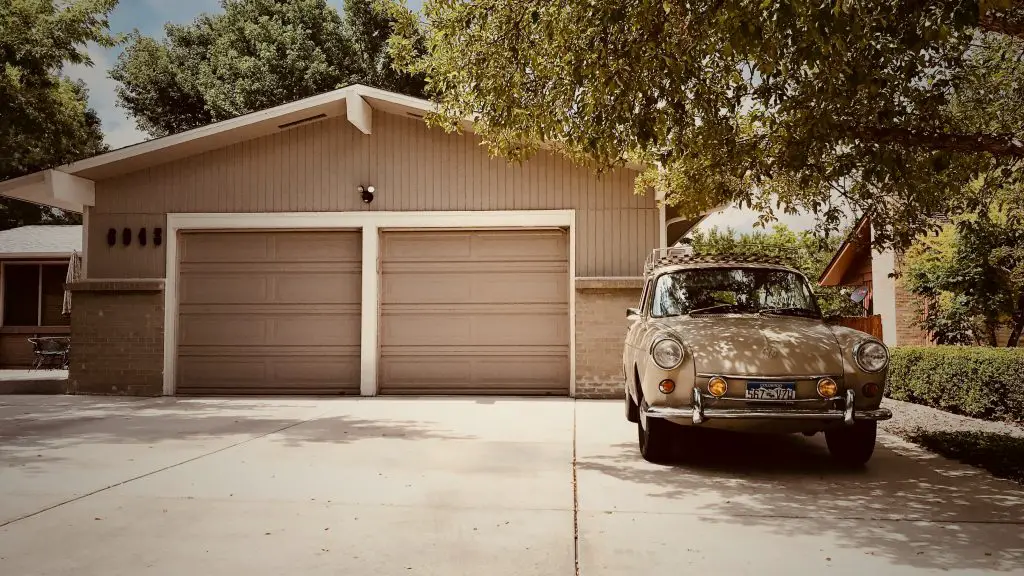 Image of a tan garage door outside a home. Source: john paulsen, unsplash