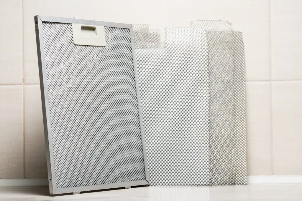 Image of aluminum mesh filters leaning on kitchen wall. Source: Adobe Stock